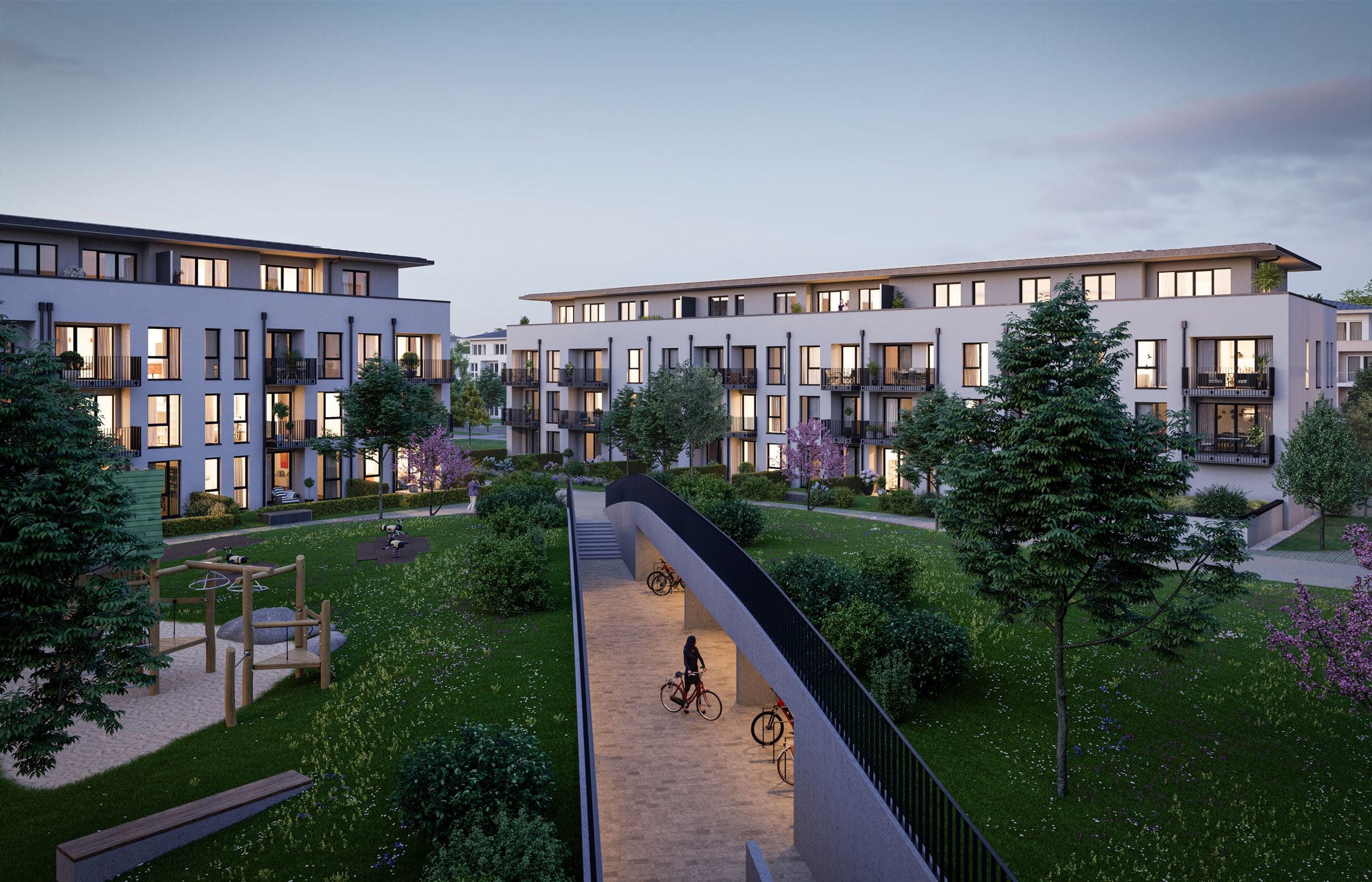 Annelies Quartier Haar bei München — begrünter Innenhof mit Spielplatz im Abendlicht
